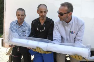 (From L) Carlo Barbante, the Italian director of the Institute for the Dynamics of Environmental Processes at the University CaFoscari in Venice, Patrick Ginot, ingeneer in research at the French Research Institute for Development (IRD) and the Laboratory of Glaciology and Environmental Geophysics (LGGE) and chief of mission at the Col du Dome and Jerome Chappellaz, director of research at the French National Center for Scientific Research (CNRS) carry a part of an ice core on August 24, 2016 2016 in Chamonix, eastern France, following the extraction of two ice cores in a glacier of the as part of the "Protecting Ice Memory project". Two ice cores of more than 120 meters were extracted before being preserved in Antarctica as part of an operation to save the "memory" of ice, threatened by global warming. / AFP / PHILIPPE DESMAZES (Photo credit should read PHILIPPE DESMAZES/AFP/Getty Images)